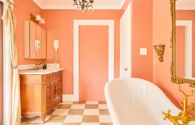 an orange bathroom with a tub and a sink at Hollywood Deluxe Homestay in Los Angeles
