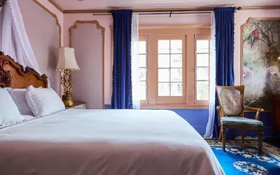 a bedroom with a large bed and a chair at Luxurious Hollywood Homestay in Los Angeles