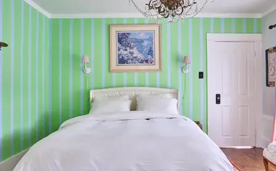 a bedroom with green striped walls and a bed at Luxurious Hollywood Homestay in Los Angeles