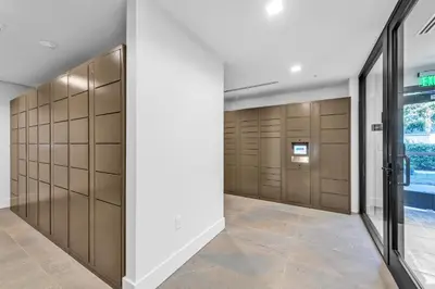 a walk in closet with wooden lockers at Global Luxury Suites in LA's Seaside in Los Angeles