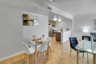 a dining room and kitchen with a table and chairs at Global Luxury Suites in LA's Seaside in Los Angeles