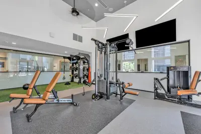 a gym with cardio equipment and a flat screen tv at Global Luxury Suites in LA's Seaside in Los Angeles