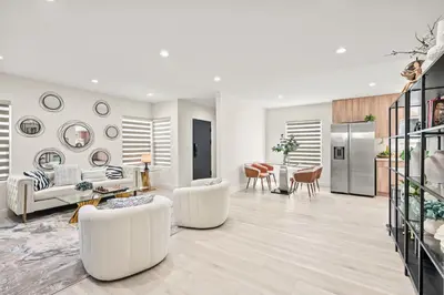 a living room with white furniture and a kitchen at Modern New 3B Home Fully Stocked & Cozy & Sunlight