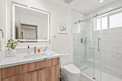a bathroom with a shower and a toilet and a sink at Modern New 3B Home Fully Stocked & Cozy & Sunlight