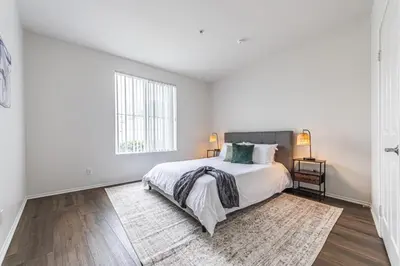 a white bedroom with a bed and a large window at 3BR Marina del Rey Condo with Pool, Hot Tub & Parking - 15 Min to LAX in Los Angeles