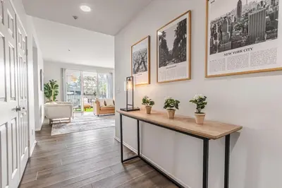 a hallway with a table and plants on a wall at 3BR Marina del Rey Condo with Pool, Hot Tub & Parking - 15 Min to LAX in Los Angeles