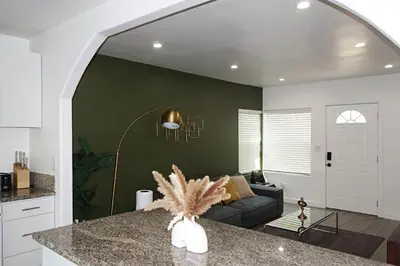 a kitchen and a living room with a couch at Casa Mid City - Centrally Located 1BR Getaway with Private Yard in Los Angeles