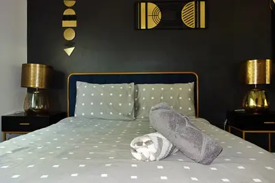 a dog laying on a bed with blankets and pillows at Casa Mid City - Centrally Located 1BR Getaway with Private Yard in Los Angeles