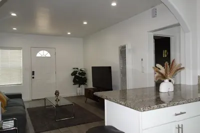 a kitchen and living room with a counter top at Casa Mid City - Centrally Located 1BR Getaway with Private Yard in Los Angeles