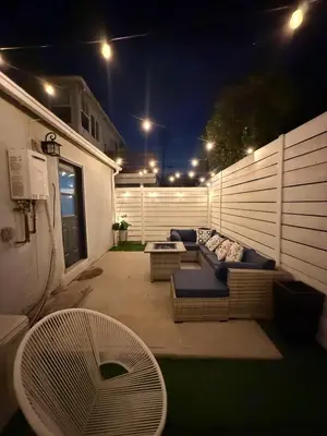 a patio at night with a couch and a table at Casa Mid City - Centrally Located 1BR Getaway with Private Yard in Los Angeles