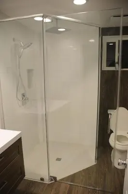 a glass shower in a bathroom with a toilet at Champagne Retreat in Upland