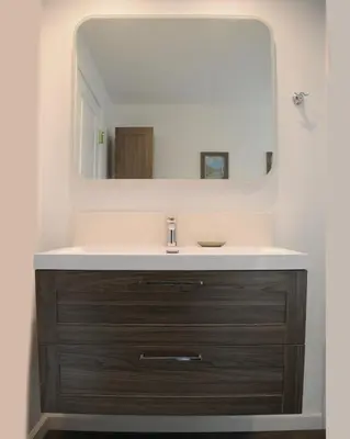 a bathroom with a sink and a mirror at Champagne Retreat in Upland