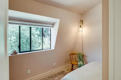 a bedroom with a bed and a window at Walk to Village Cozy Cabin in Pine Mountain Club! in Pine Mountain Club