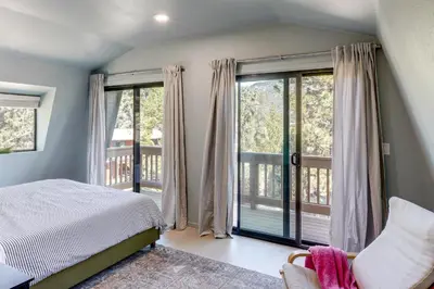 a bedroom with a bed and a balcony at Walk to Village Cozy Cabin in Pine Mountain Club! in Pine Mountain Club