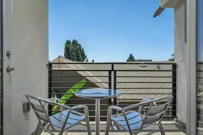 a patio with two chairs and a table on a balcony at Chic 1 Bedroom Loft with Balcony Hollywood Sign View Free Gated Parking Full Kitchen in Los Angeles
