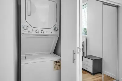a kitchen with a washer and dryer in a refrigerator at Stylish 1 Bedroom Loft in Hollywood Balcony Free Gated Parking In Unit Laundry in Los Angeles