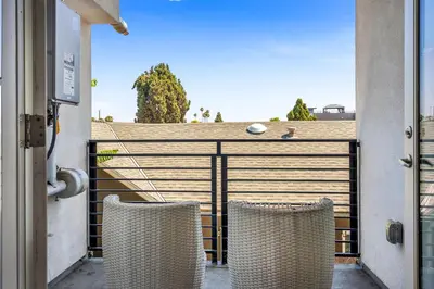 two chairs on a balcony with a fence at Stylish 1 Bedroom Loft in Hollywood Balcony Free Gated Parking In Unit Laundry in Los Angeles