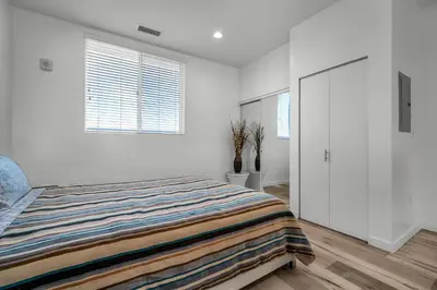 a white bedroom with a bed and two windows at Stylish 1 Bedroom Loft in Hollywood Balcony Free Gated Parking In Unit Laundry in Los Angeles