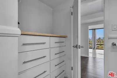 a kitchen with white cabinets and a view of the ocean at A Stunning Luxury Resort-Style Furnished Condominium Plus All Inclusive Amenities! in Los Angeles