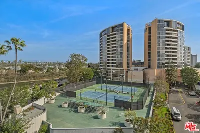 an aerial view of a tennis court with two buildings at A Stunning Luxury Resort-Style Furnished Condominium Plus All Inclusive Amenities! in Los Angeles