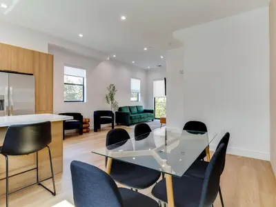 a dining room with a glass table and chairs at Modern Luxe Retreat Three-Bedroom #4 in Los Angeles