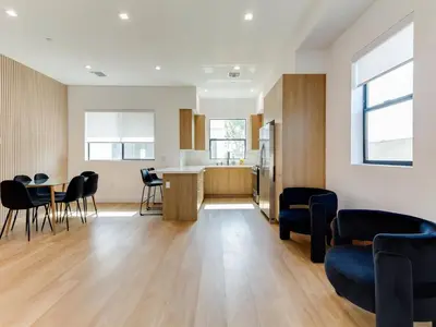 a kitchen and a living room with a table and chairs at Modern Luxe Retreat Three-Bedroom #4 in Los Angeles