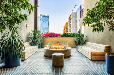 a patio with a table and benches and plants at Loft & Luxe Hollywood with FREE PARKING in Los Angeles