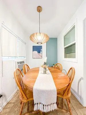 a dining room with a wooden table and chairs at Relaxed and Cozy Poolside Studio - LOU2 - BUR in Burbank
