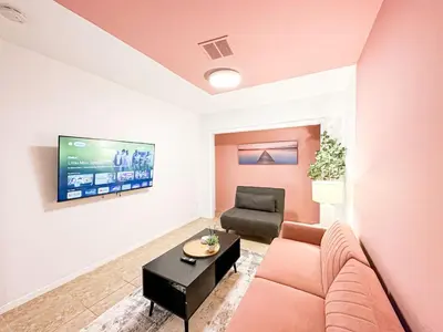 a living room with a couch and a tv at Relaxed and Cozy Poolside Studio - LOU2 - BUR in Burbank