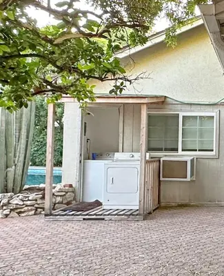 an outdoor kitchen with a stove and a refrigerator at Relaxed and Cozy Poolside Studio - LOU2 - BUR in Burbank