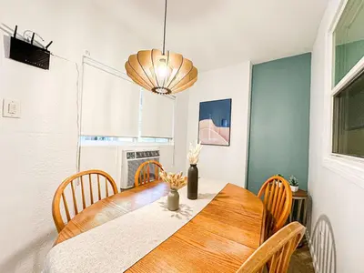 a dining room with a wooden table and chairs at Relaxed and Cozy Poolside Studio - LOU2 - BUR in Burbank