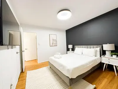 a bedroom with a large bed and a black wall at 6BR Pool Escape for Friends and Family - LOU1 - BUR in Burbank