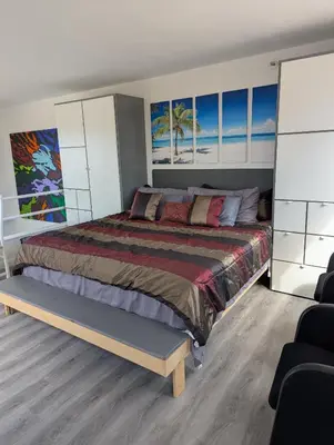 a bedroom with a large bed with white cabinets at 31 night required rental Waterfront penthouse 180 ocean view in Redondo Beach