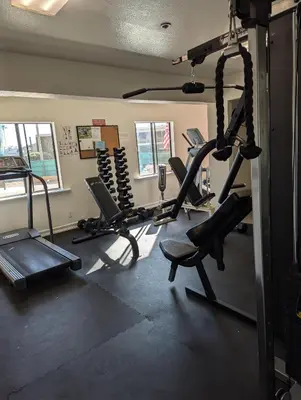 a gym with several tread machines in a room at 31 night required rental Waterfront penthouse 180 ocean view in Redondo Beach