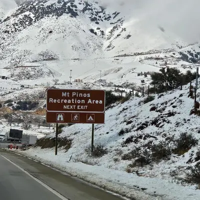 a sign on the side of a road in the snow at Cozy Mountain Retreat in Frazier Park