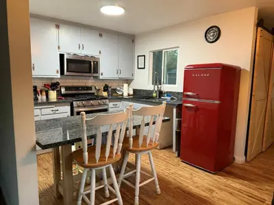 a kitchen with a red refrigerator and two chairs at Cozy Mountain Retreat in Frazier Park