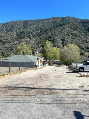 a parking lot with a truck parked in front of a mountain at Cozy Mountain Retreat in Frazier Park