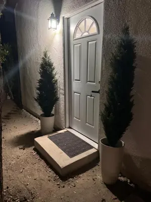 a white door with two potted trees in front of it at Stunning Guest House in West Hills California in Hughes-Canoga Park Heliport