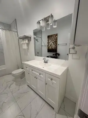 a white bathroom with a sink and a toilet at Stunning Guest House in West Hills California in Hughes-Canoga Park Heliport