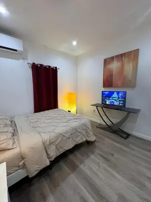 a bedroom with a bed and a flat screen tv at Stunning Guest House in West Hills California in Hughes-Canoga Park Heliport