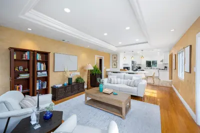 a living room with white furniture and a kitchen at The Luxe Escape | Near LAX & West LA Hotspots in Los Angeles
