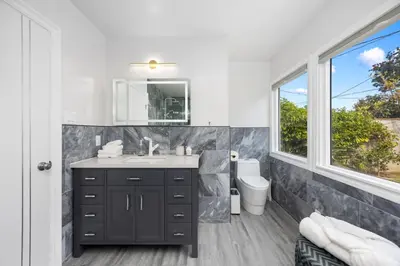 a bathroom with a sink and a toilet and a window at The Luxe Escape | Near LAX & West LA Hotspots in Los Angeles