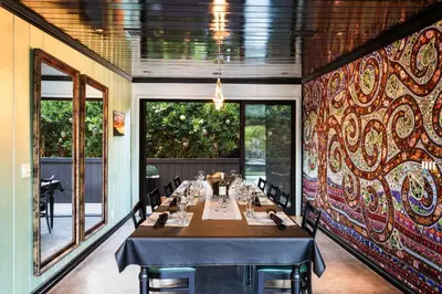 a dining room with a long table and a wall of windows at New Listing Burbank Bungalow by Colby&Conrad in Los Angeles