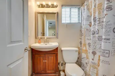 a bathroom with a toilet and a sink and a mirror at 4 Mi to Beverly Hills Quiet LA Gem with Shared Yard in Los Angeles