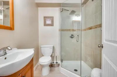 a bathroom with a shower and a toilet and a sink at 4 Mi to Hollywood Mid-Wilshire Couples Retreat in Los Angeles