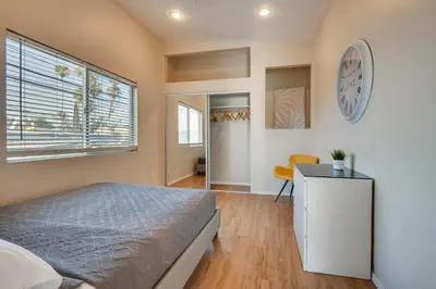 a bedroom with a bed and a clock on the wall at 9 Mi to Airport WFH-Friendly Apt in Los Angeles! in Los Angeles