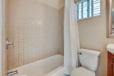 a bathroom with a toilet and a tub and a sink at 9 Mi to Airport WFH-Friendly Apt in Los Angeles! in Los Angeles