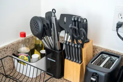 a knife block with utensils in it on a counter at Cozy 2BR2BA Guest House in Alhambra in Alhambra