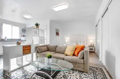 a living room with a couch and a glass table at Cozy Guesthouse near Downtown Alhambra in Alhambra