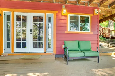 a green chair sitting on the front of a house at 3 Mi to Lake Arrowhead Village Dog-Friendly Cabin in Lake Arrowhead